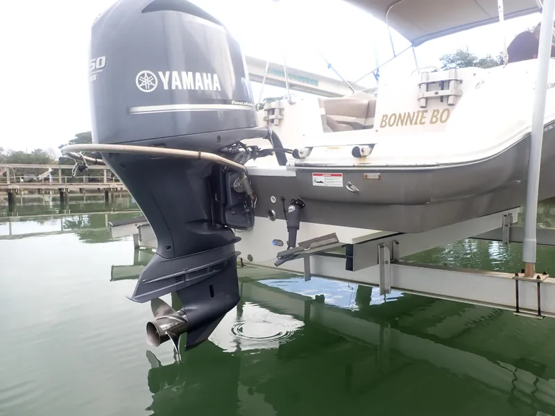 Slide: The Image of 2016 Hurricane SunDeck 2690 OB with Yamaha outboard motor on a lift. - 46