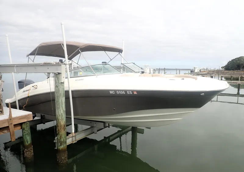 Slide: The Image of 2016 Hurricane SunDeck 2690 OB boat docked with canopy, side view. - 6