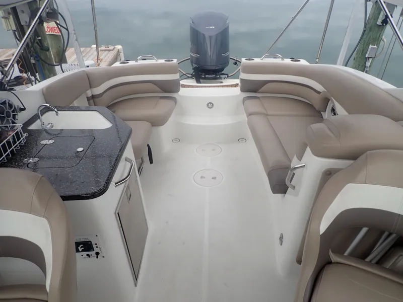 Slide: The Image of 2016 Hurricane SunDeck 2690 OB boat interior with seating and kitchenette. - 8