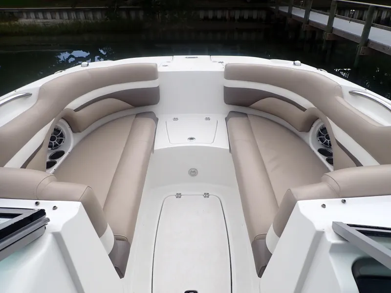 Slide: The Image of 2016 Hurricane SunDeck 2690 OB boat interior with beige seating and speakers. - 9