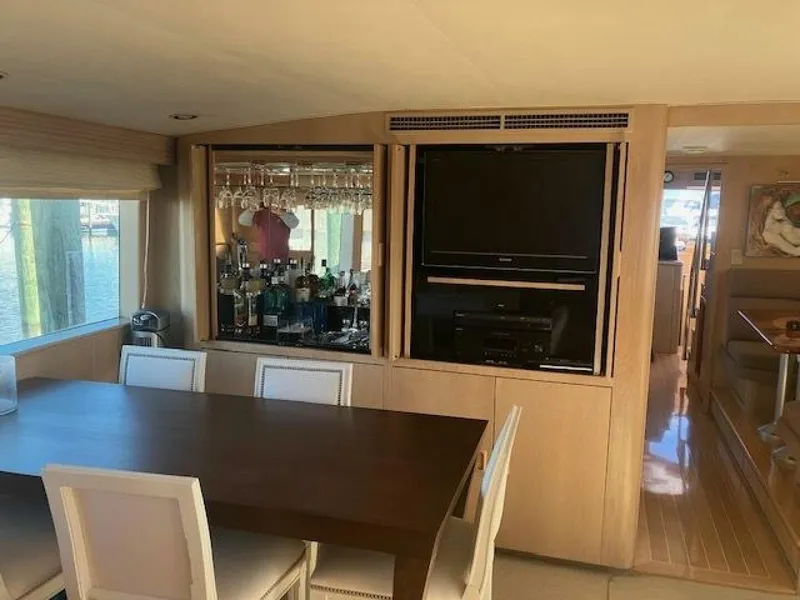 Slide: The Image of Interior of 1996 Hatteras 70 Sport Deck Motor Yacht with dining area and entertainment center. - 14