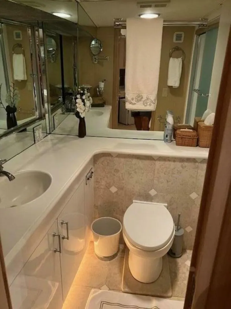 Slide: The Image of Bathroom interior of 1996 Hatteras 70 Sport Deck Motor Yacht, featuring elegant fixtures and decor. - 21