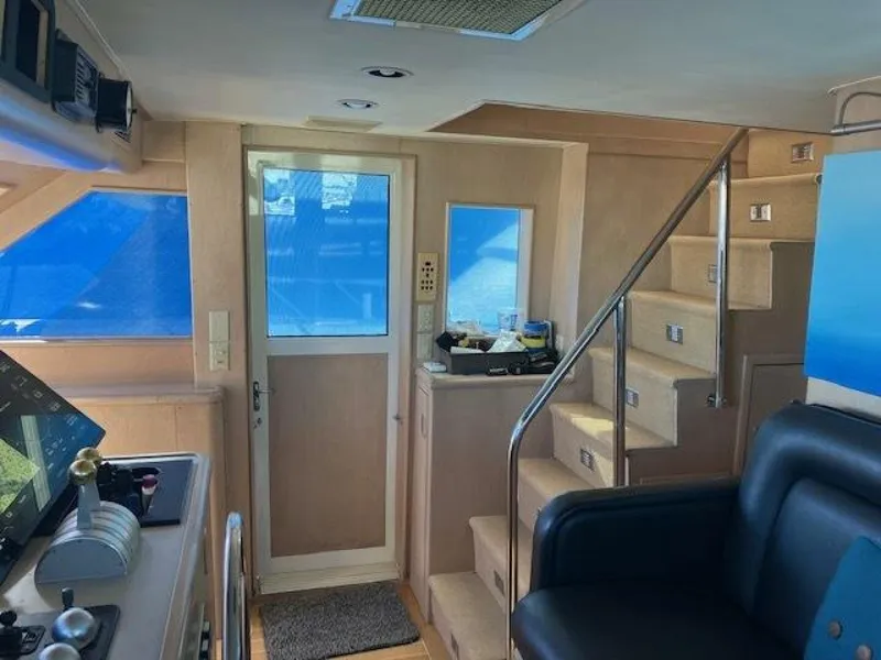 Slide: The Image of Interior of 1996 Hatteras 70 Sport Deck Motor Yacht with stairs and control panel. - 27