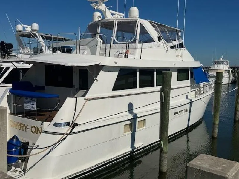 Slide: The Image of 1996 Hatteras 70 Sport Deck Motor Yacht docked at marina. - 3