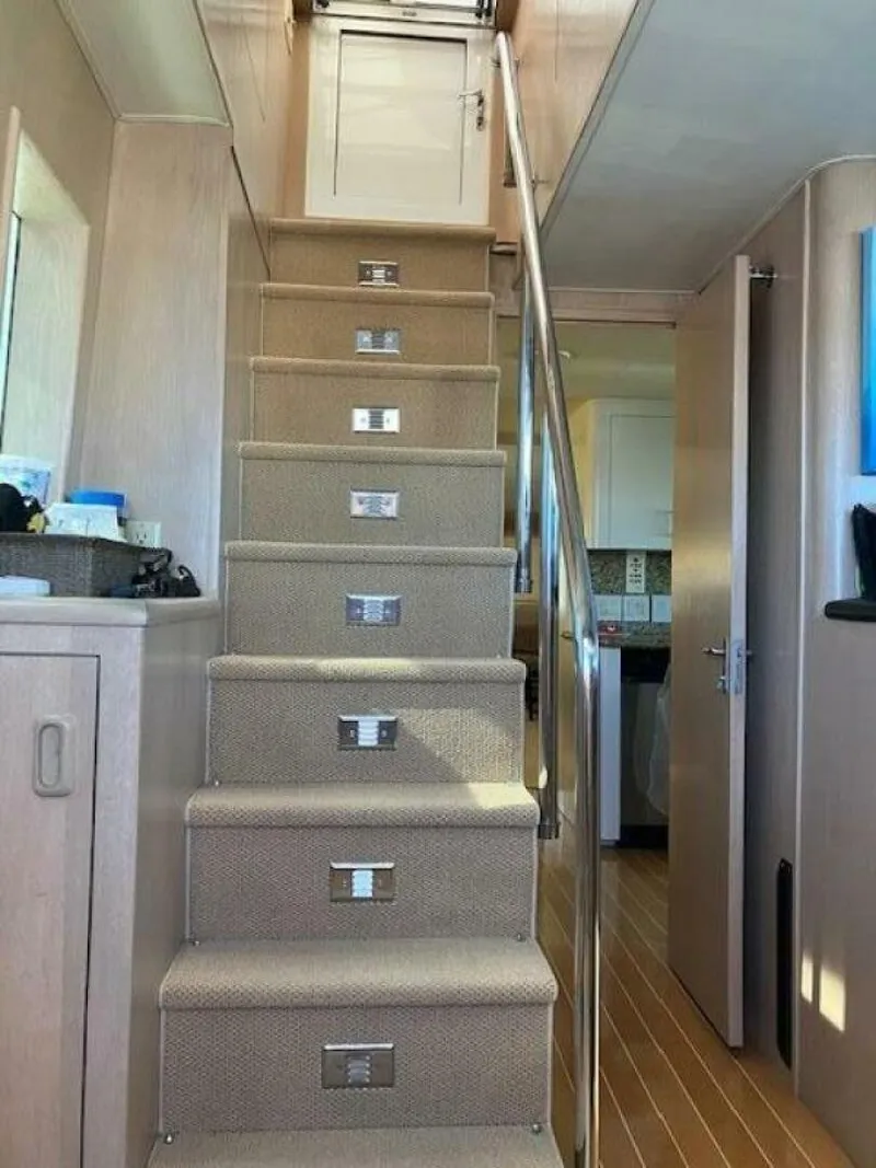 Slide: The Image of Interior stairs of 1996 Hatteras 70 Sport Deck Motor Yacht with carpet and railing. - 30