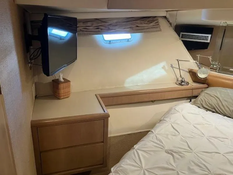 Slide: The Image of Interior of 1996 Hatteras 70 Sport Deck Motor Yacht bedroom with TV and window. - 34