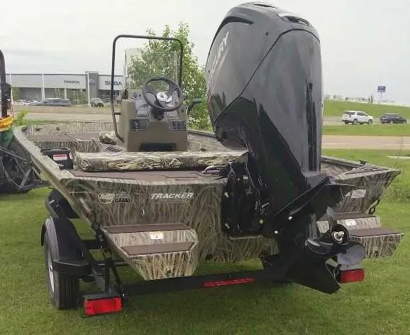 Slide: The Image of 2025 Tracker Grizzly 1860 CC boat with camouflage design and powerful outboard motor. - 3
