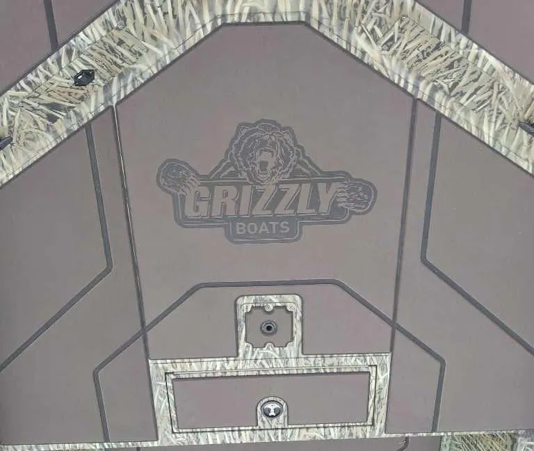 Slide: The Image of 2025 Tracker Grizzly 1860 CC boat deck with logo and camouflage accents. - 4