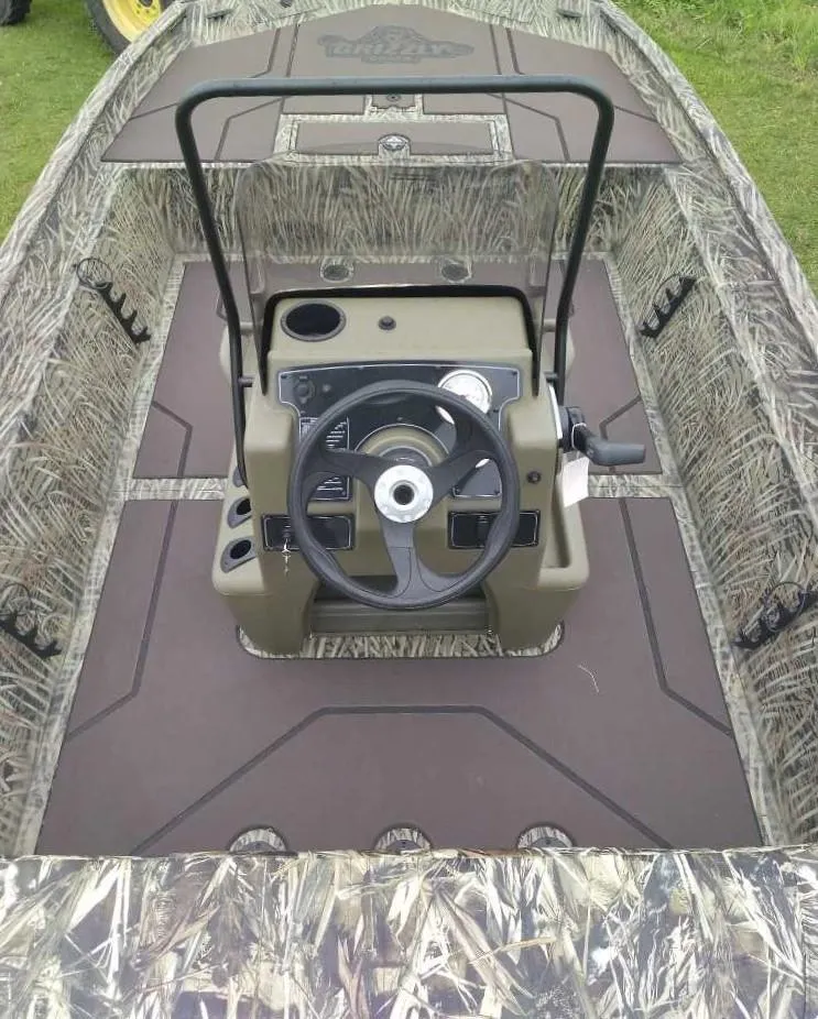 Slide: The Image of 2025 Tracker Grizzly 1860 CC boat interior with camouflage design and steering console. - 5