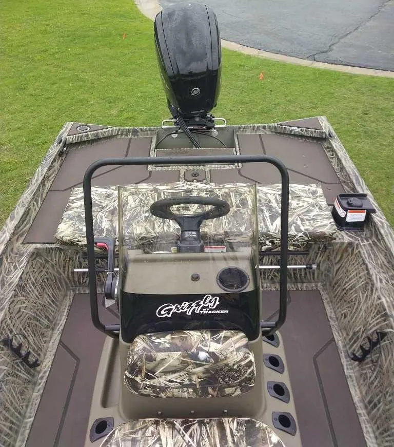 Slide: The Image of 2025 Tracker Grizzly 1860 CC boat with camouflage design and steering console. - 7