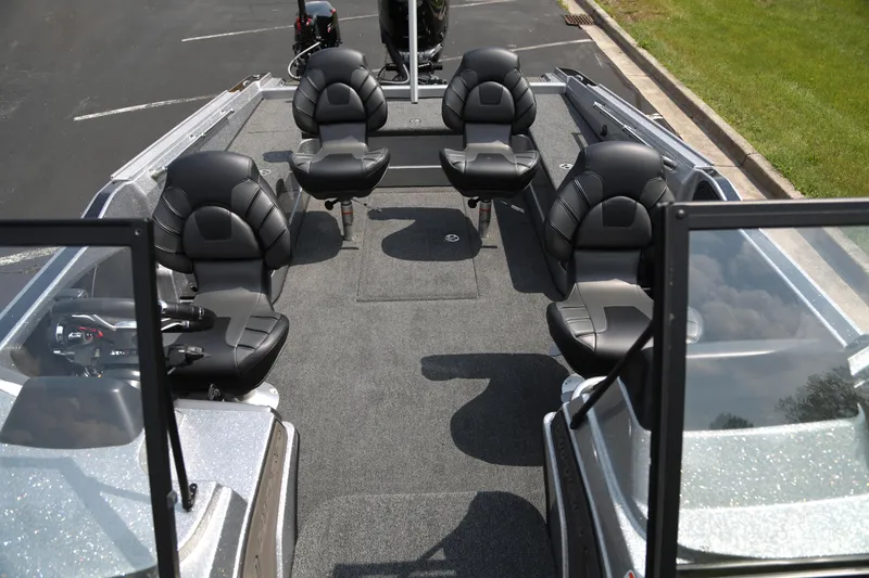Slide: The Image of 2025 Nitro ZV21 Pro boat interior with four black seats and spacious deck. - 3