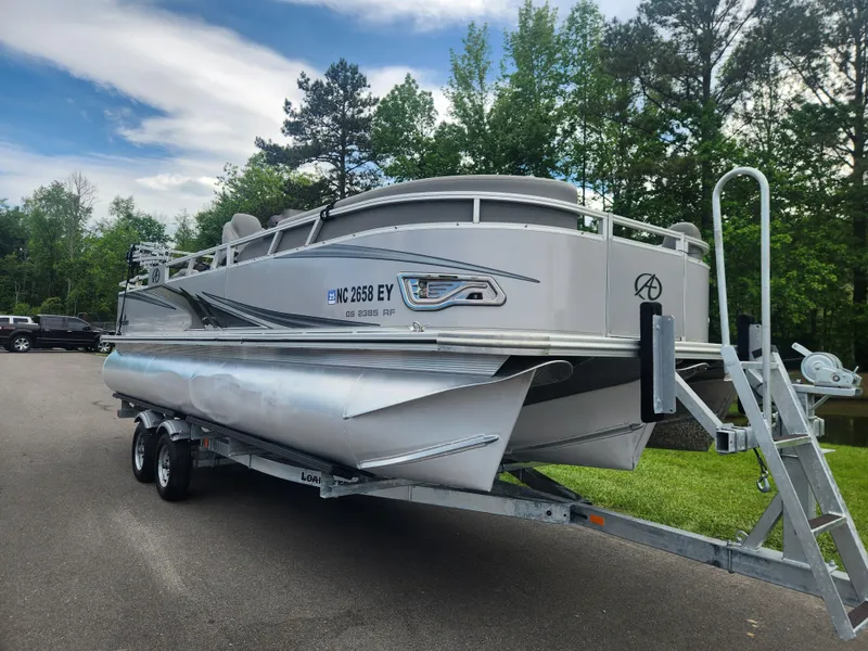 Slide: The Image of 2022 Avalon GS RF 2385 pontoon boat on trailer, parked outdoors. - 1