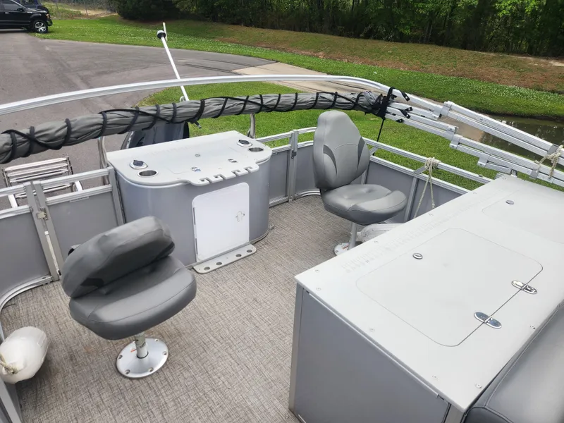 Slide: The Image of 2022 Avalon GS RF 2385 pontoon boat interior with gray seating and control panel. - 11
