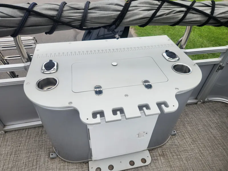 Slide: The Image of 2022 Avalon GS RF 2385 boat console with cup holders and storage compartment. - 13