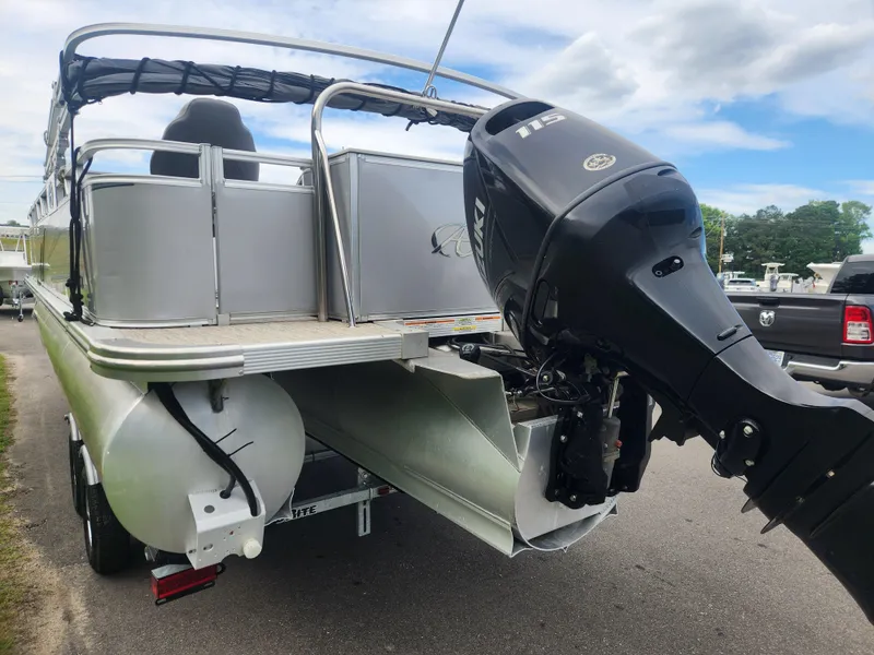 Slide: The Image of 2022 Avalon GS RF 2385 pontoon boat with powerful outboard motor, parked on a trailer. - 3