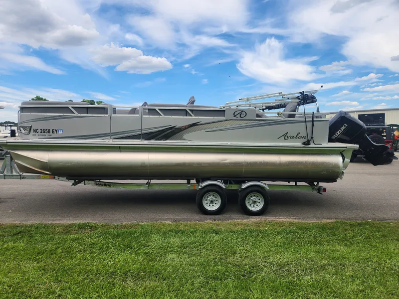 Slide: The Image of 2022 Avalon GS RF 2385 pontoon boat on trailer under blue sky. - 5