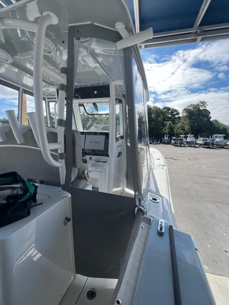 Slide: The Image of 2025 Sea Hunt Gamefish 28 Forward Seating boat, interior view with console and seating. - 13
