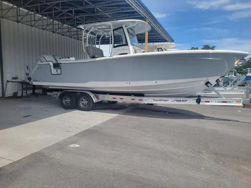 Slide: The Image of 2025 Sea Hunt Gamefish 28 Forward Seating boat on trailer in marina. - 3