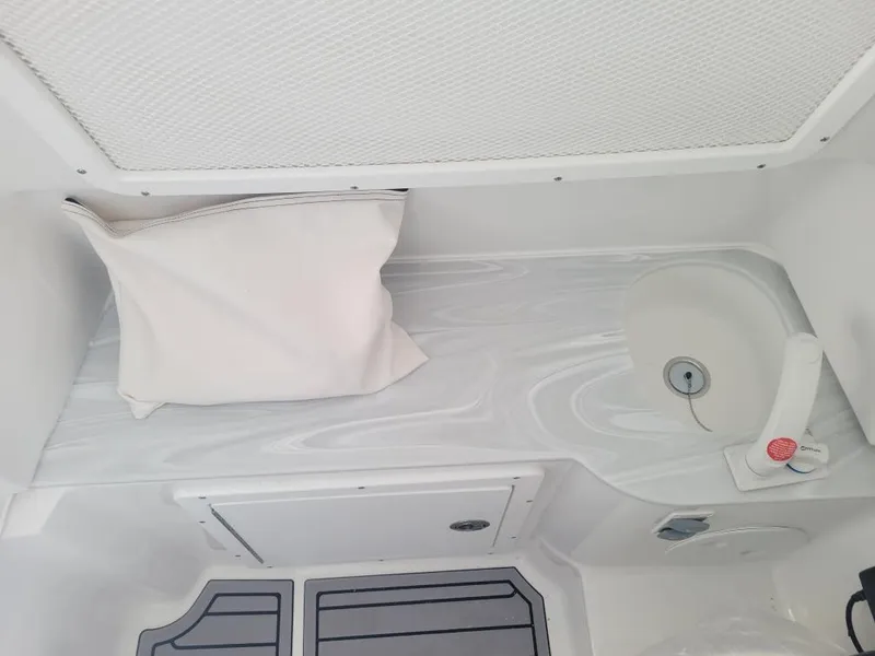 Slide: The Image of 2025 Sea Hunt Gamefish 28 Forward Seating interior with cushion and sink. - 8