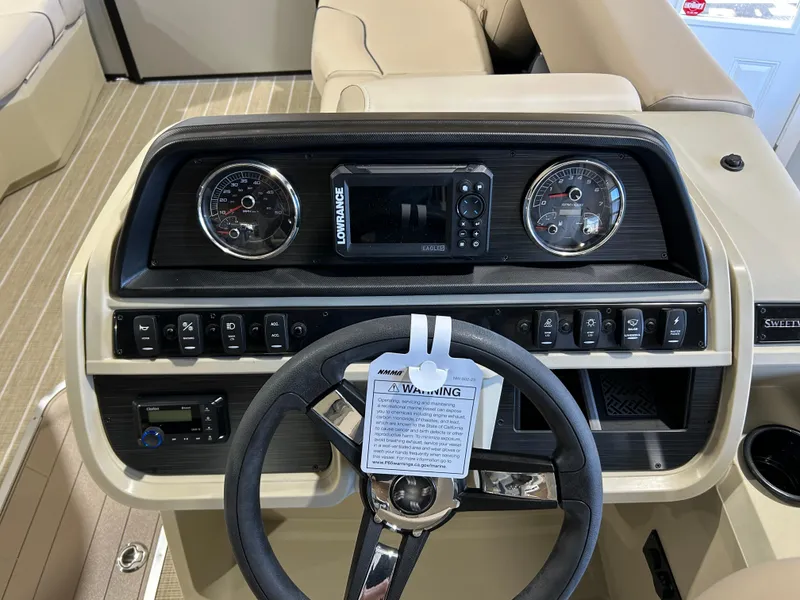 Slide: The Image of 2025 Godfrey Sweetwater 2286 QS dashboard with steering wheel and control panel. - 4