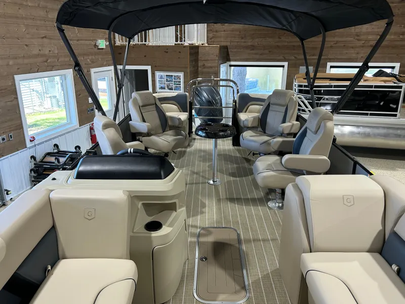 Slide: The Image of 2025 Godfrey Sweetwater 2286 QS pontoon boat interior with plush seating and canopy. - 5