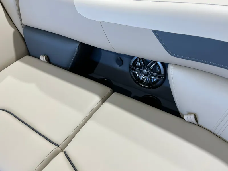 Slide: The Image of 2025 Godfrey Sweetwater 2286 QS boat interior with beige seating and speaker system. - 6
