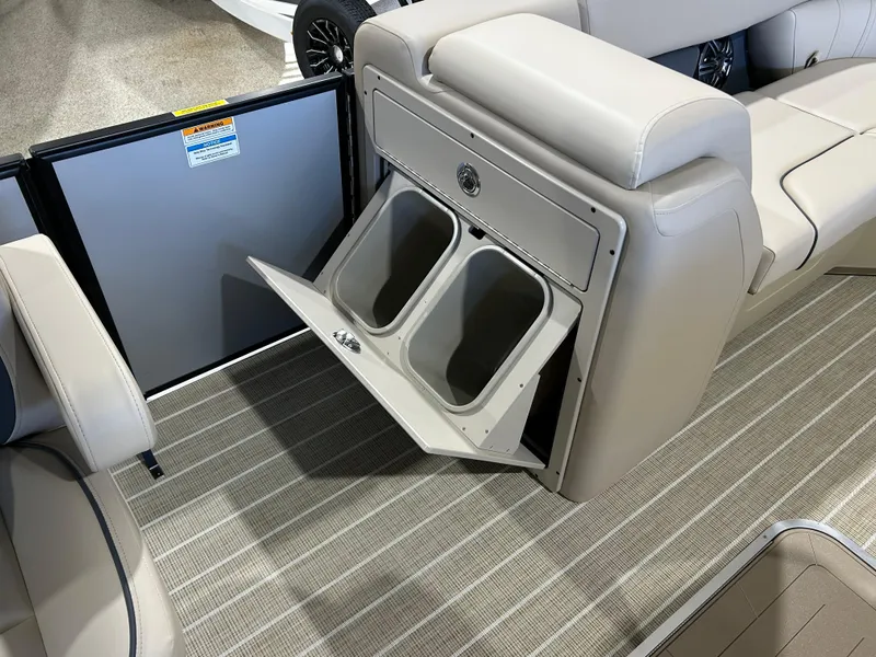 Slide: The Image of 2025 Godfrey Sweetwater 2286 QS boat interior with storage compartment and seating. - 8