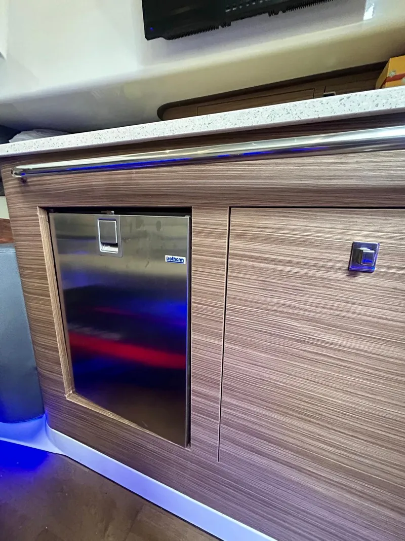 Slide: The Image of 2019 Boston Whaler 420 Outrage interior with wood finish and stainless steel accents. - 10