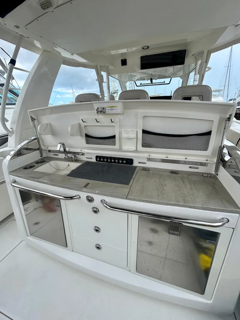 Slide: The Image of 2019 Boston Whaler 420 Outrage boat interior with modern kitchen amenities. - 14