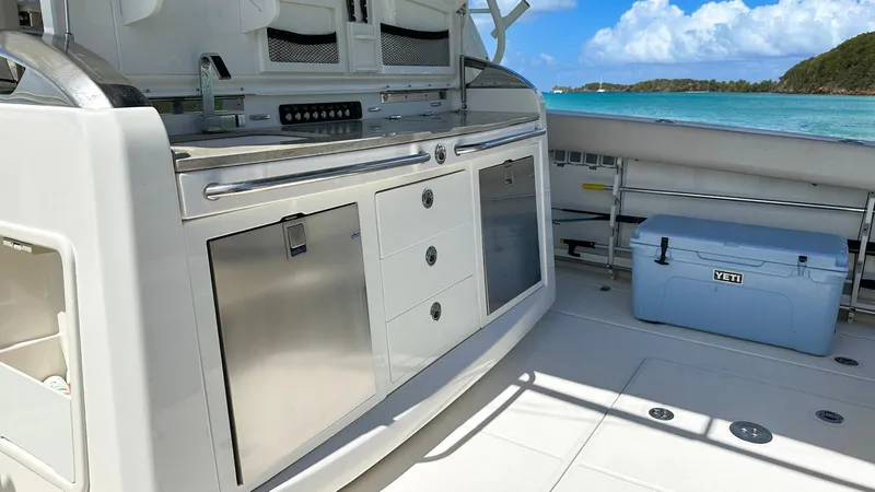 Slide: The Image of 2019 Boston Whaler 420 Outrage boat interior with stainless steel kitchen and ocean view. - 15