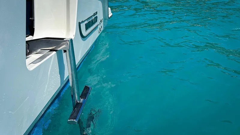 Slide: The Image of Boston Whaler 420 Outrage 2019 boat ladder in clear blue water. - 18