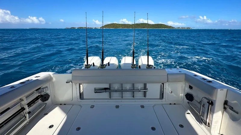 Slide: The Image of 2019 Boston Whaler 420 Outrage boat with fishing rods, cruising on open sea. - 19