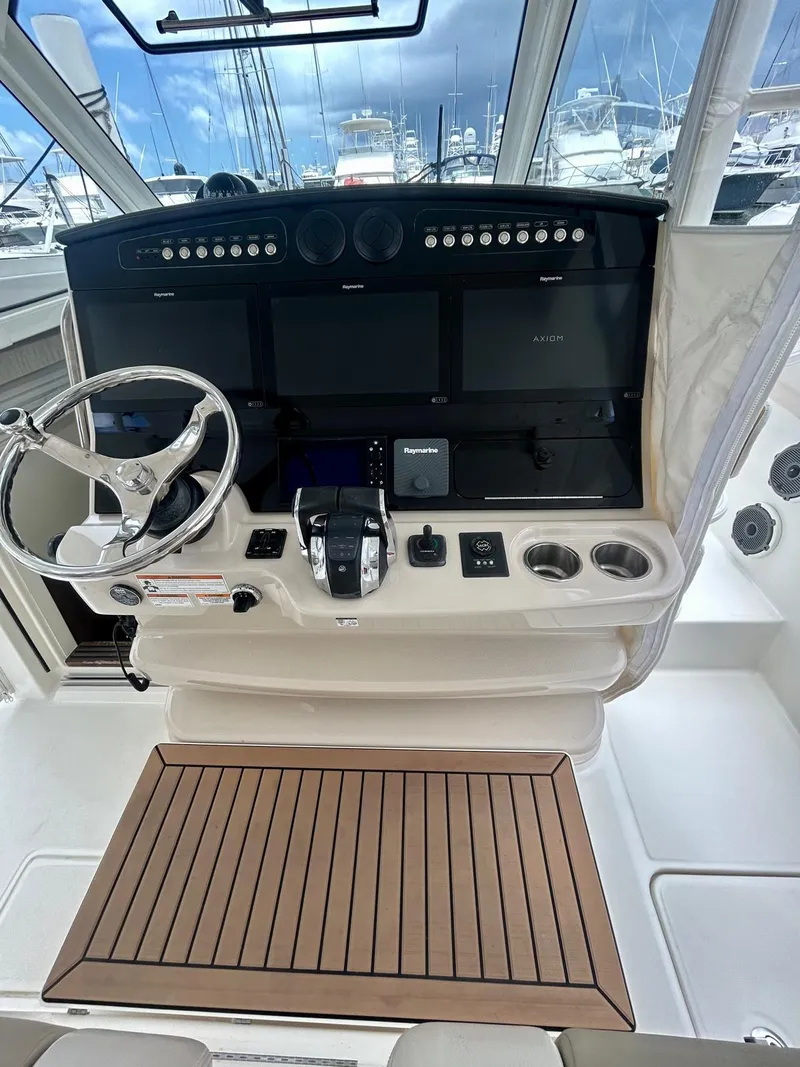 Slide: The Image of 2019 Boston Whaler 420 Outrage helm with advanced navigation controls and wooden flooring. - 5