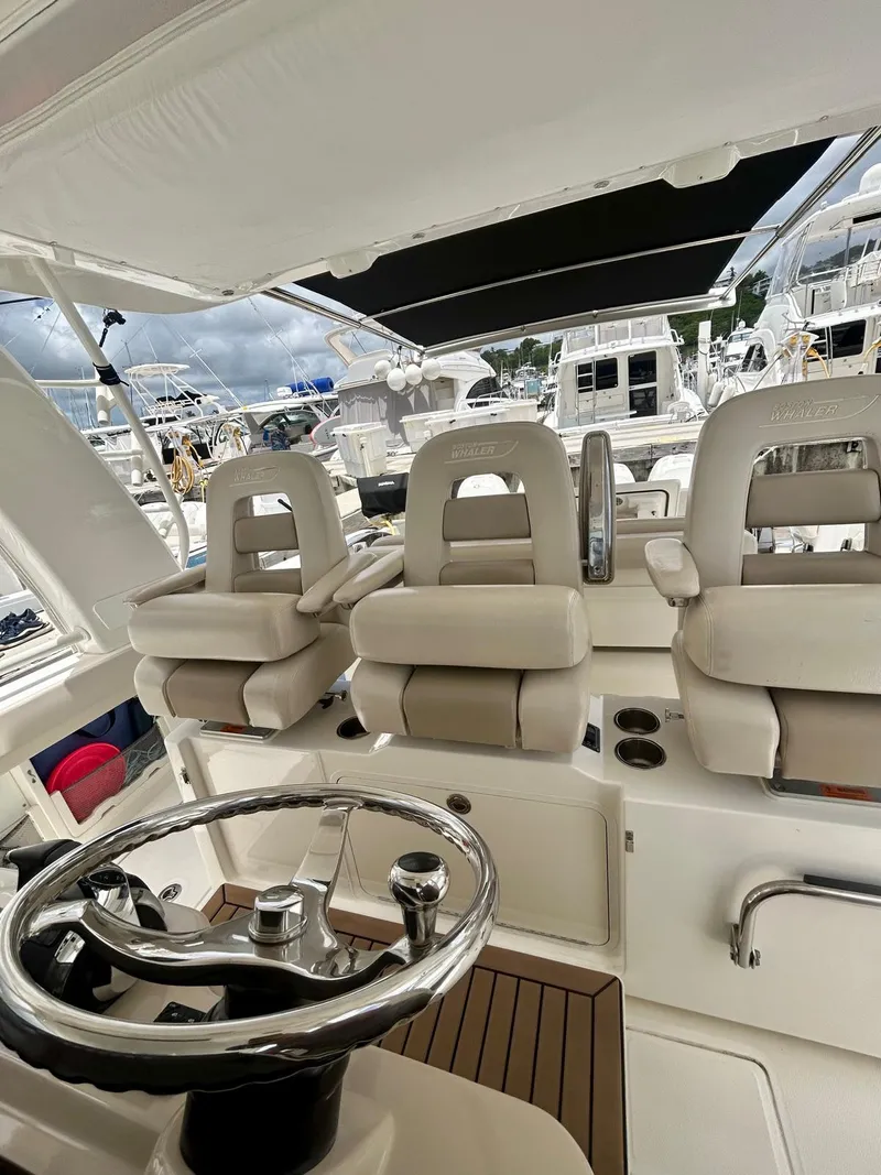 Slide: The Image of 2019 Boston Whaler 420 Outrage helm with luxurious seating and modern controls. - 7
