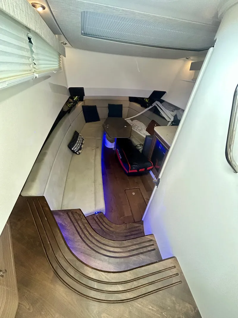 Slide: The Image of Interior of 2019 Boston Whaler 420 Outrage with modern seating and ambient lighting. - 8