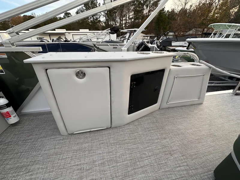 Slide: The Image of 2025 Tahoe Pontoon LTZ Cruise Rear Bench with storage compartments on deck. - 3