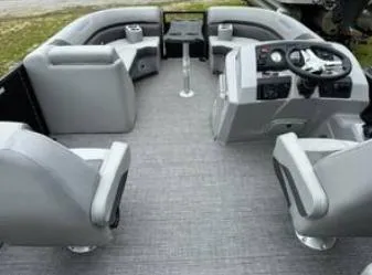 Slide: The Image of Interior of a 2025 Bennington 22 SXSR pontoon boat with gray seating and steering console. - 5