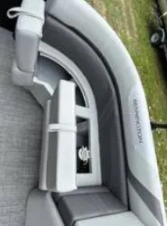 Slide: The Image of 2025 Bennington 22 SXSR boat interior with gray seating and storage compartment. - 7