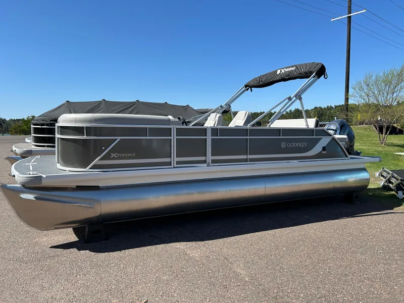 The Image of 2025 Godfrey Xperience 2286 SFL pontoon boat parked on a sunny day. - 1
