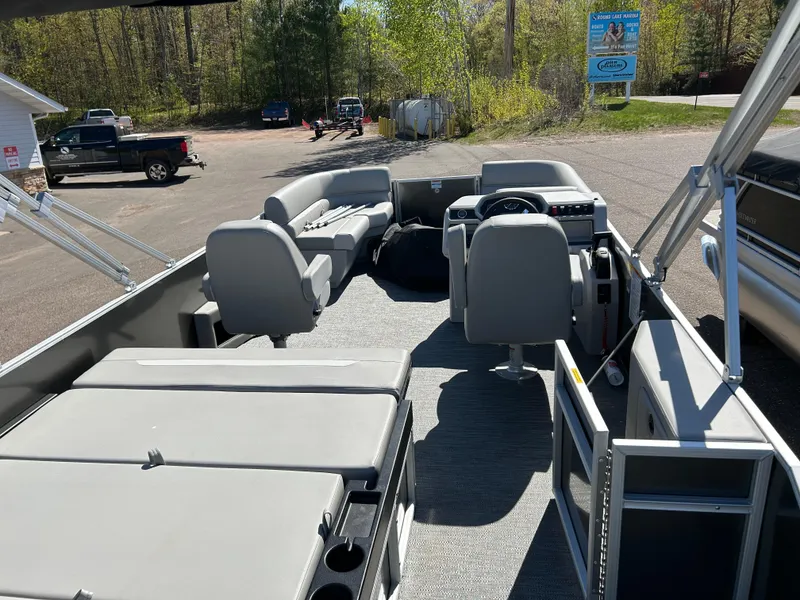 Slide: The Image of 2025 Godfrey Xperience 2286 SFL pontoon boat interior with seating and steering console. - 6