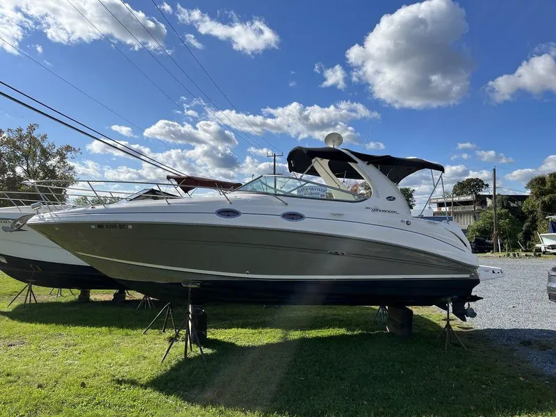 The Image of 2006 Sea Ray 280 Sundancer boat on display under a clear blue sky. - 0