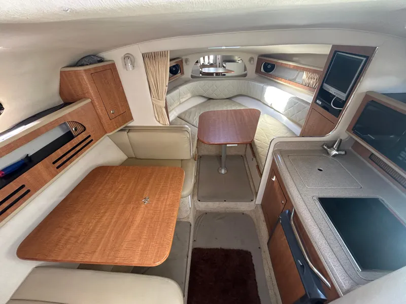 Slide: The Image of Interior of 2006 Sea Ray 280 Sundancer boat with kitchenette and seating area. - 7