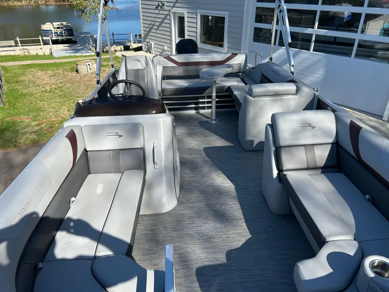 Slide: The Image of 2022 Bennington 22 SX SBST pontoon boat with spacious seating and modern design. - 4