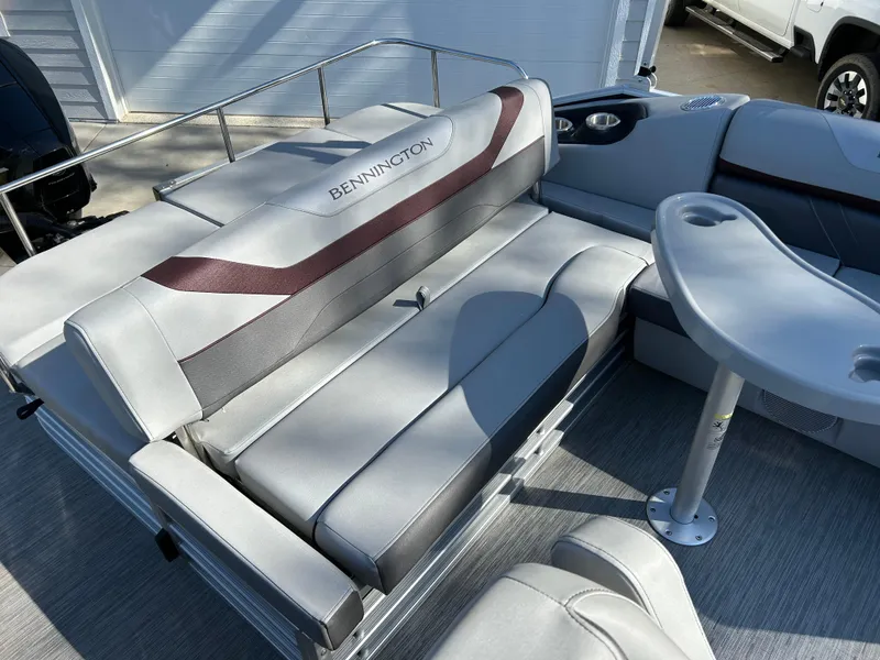 Slide: The Image of 2022 Bennington 22 SX SBST pontoon boat interior with gray seating and table. - 6