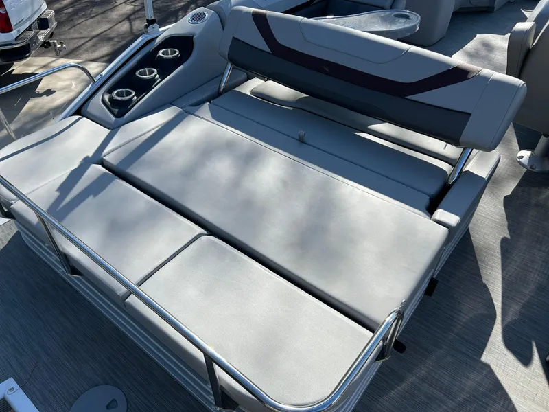 Slide: The Image of 2022 Bennington 22 SX SBST boat seating area with cup holders and sleek design. - 7