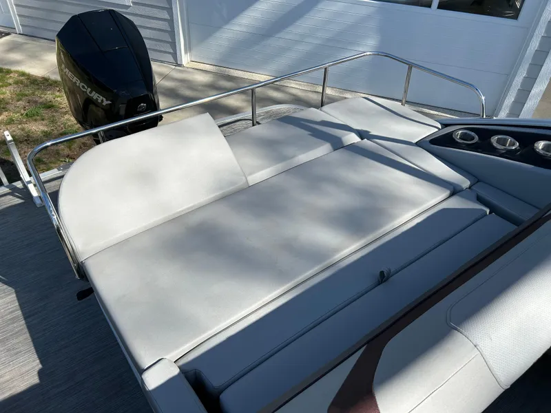 Slide: The Image of 2022 Bennington 22 SX SBST boat with spacious seating and Mercury outboard motor. - 8