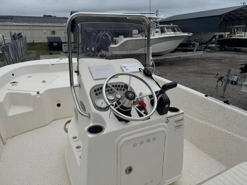 Slide: The Image of 2018 Carolina Skiff 198 DLV boat console with steering wheel and controls. - 5