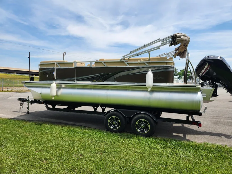 Slide: The Image of 2022 Avalon VLS 2080 QL pontoon boat on trailer, parked on grass. - 4