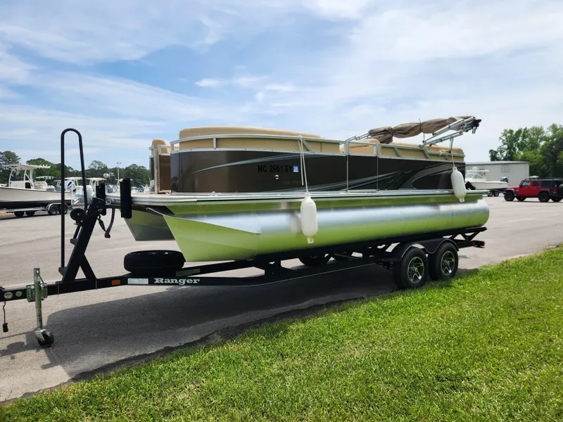 Slide: The Image of 2022 Avalon VLS 2080 QL pontoon boat on trailer, parked on grass. - 6