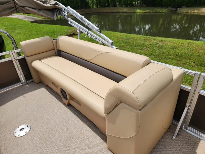 Slide: The Image of 2022 Avalon VLS 2080 QL pontoon boat with beige seating by a serene lake. - 9